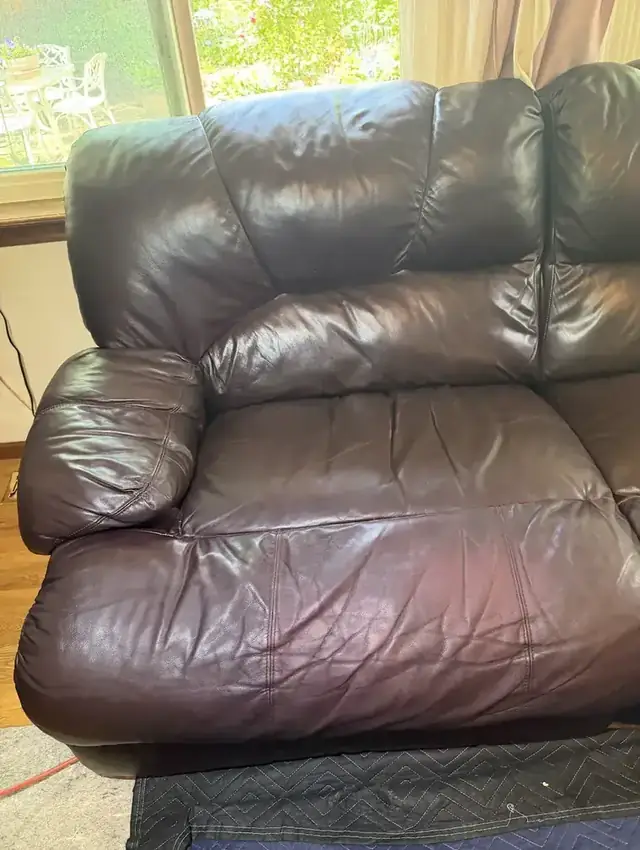 Worn leather recliner armrest before repair
